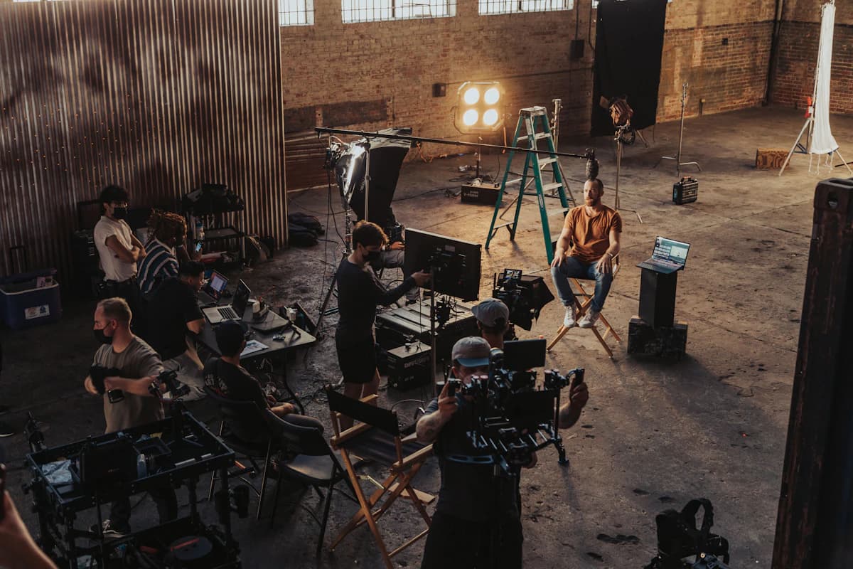 A crew standing around a camera set-up on location.